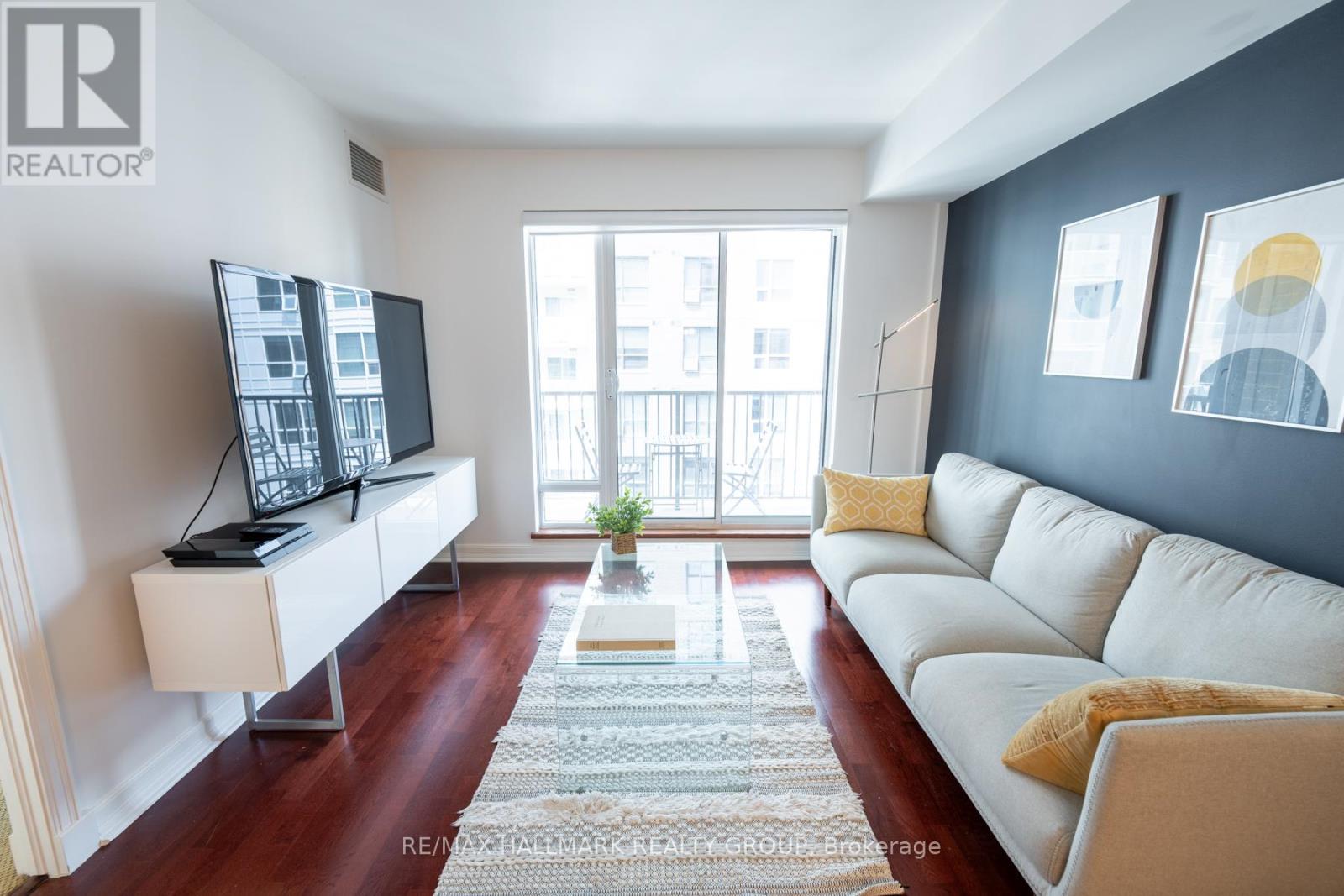 Living Room w/Hardwood Floors and Walk-Out Balcony