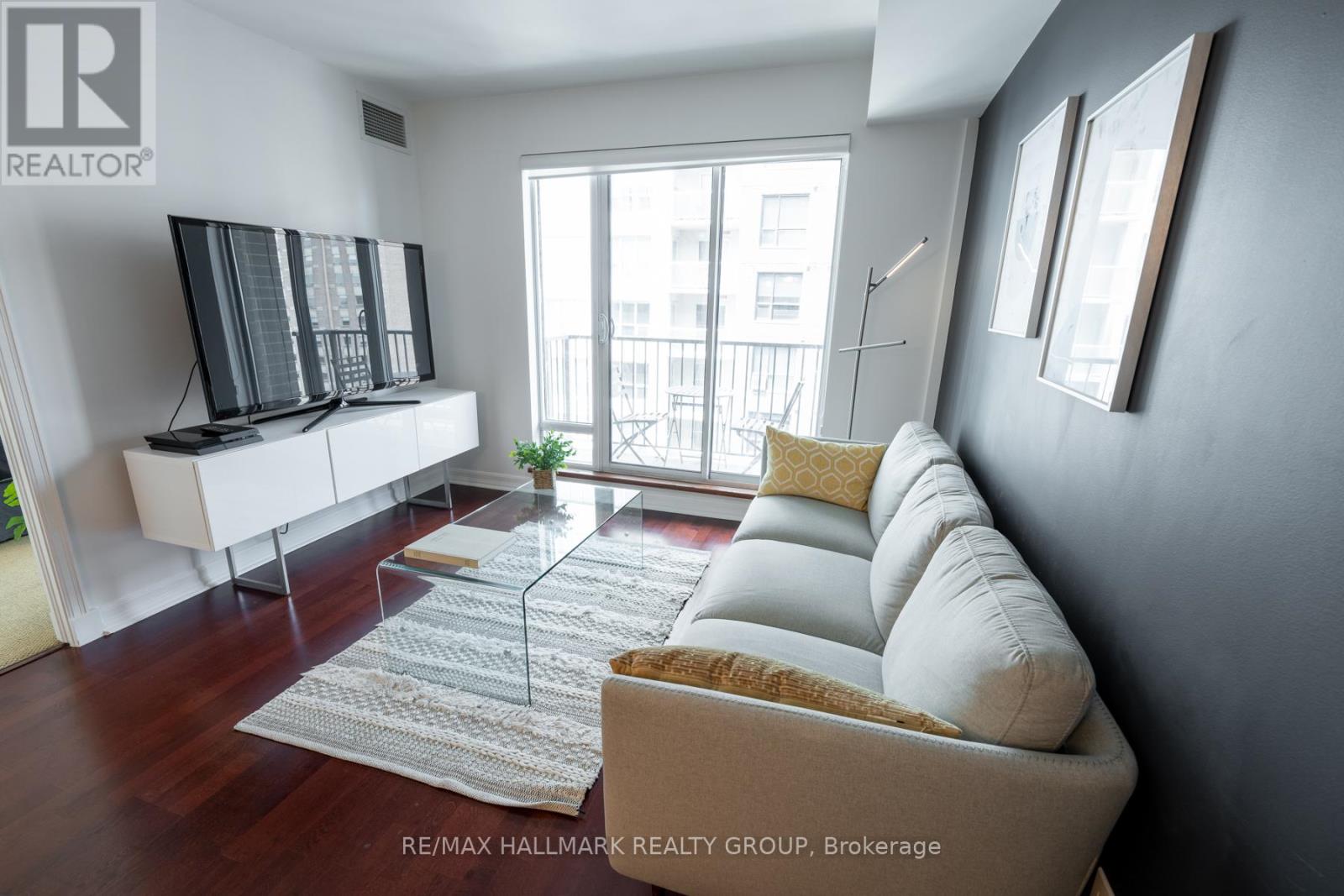 Living Room w/Hardwood Floors and Walk-Out Balcony