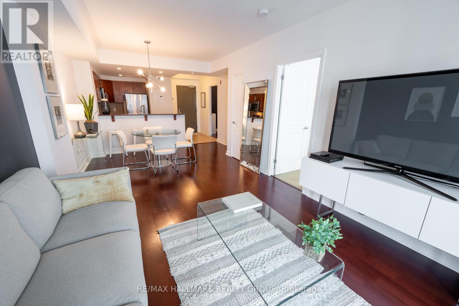 Living Room w/Hardwood Floors and Walk-Out Balcony