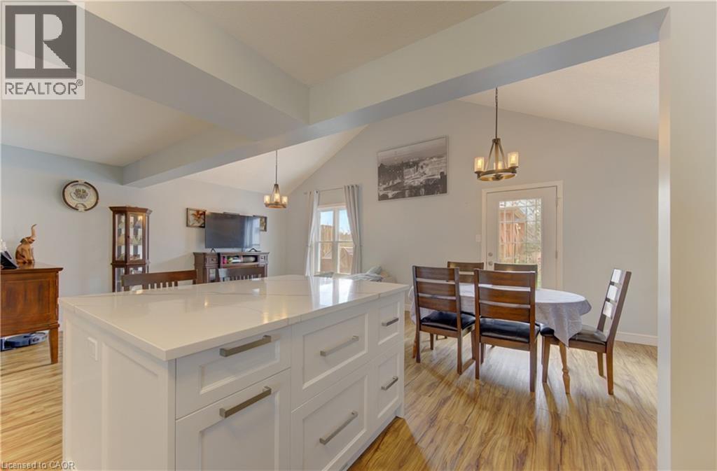 Central kitchen island featuring a light-toned countertop and white cabinetry