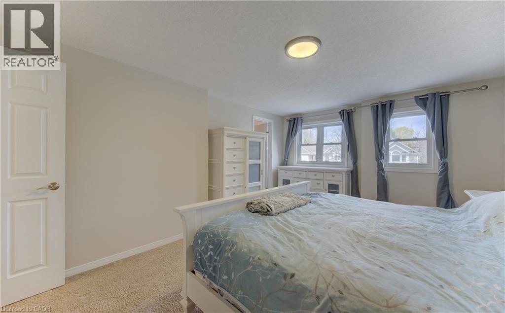Carpeted bedroom with neutral wall tones and a white interior door