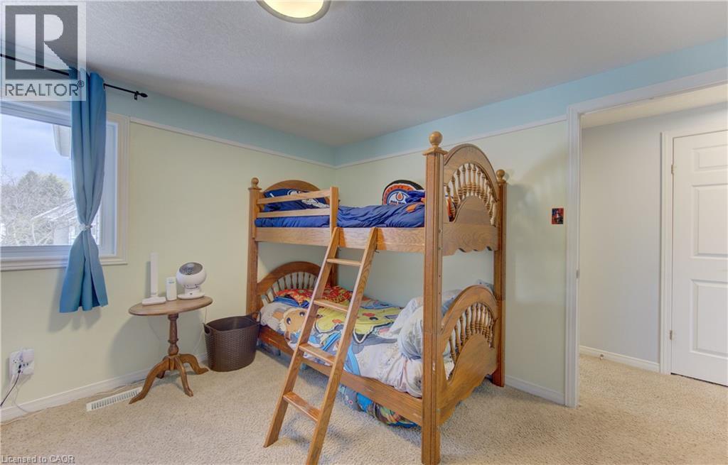 Room featuring a window with natural light, light-toned walls, and soft carpet flooring