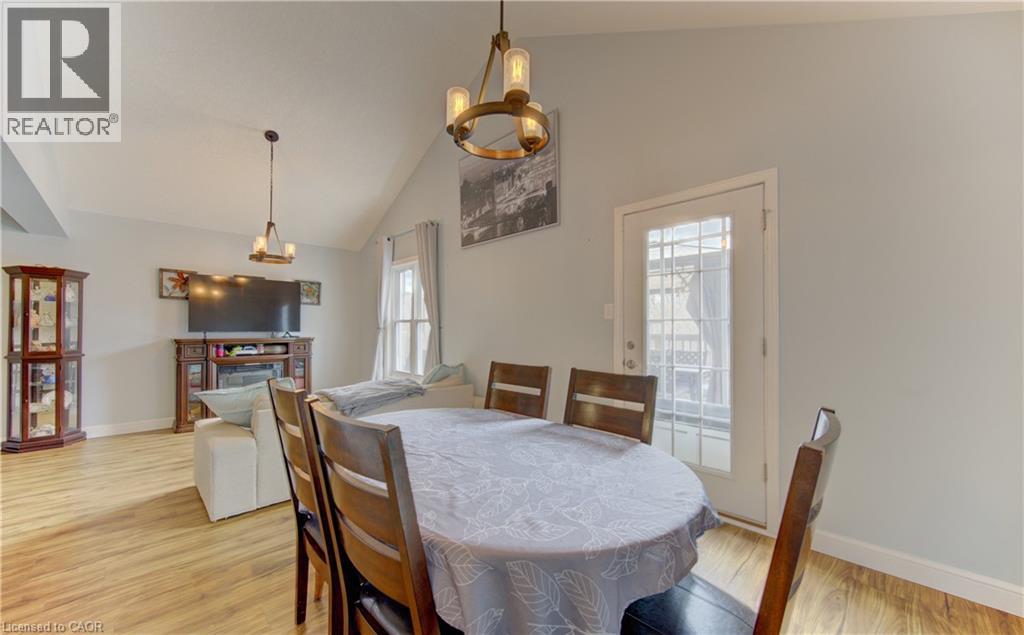 Open-concept living space featuring wood-finish flooring and a vaulted ceiling