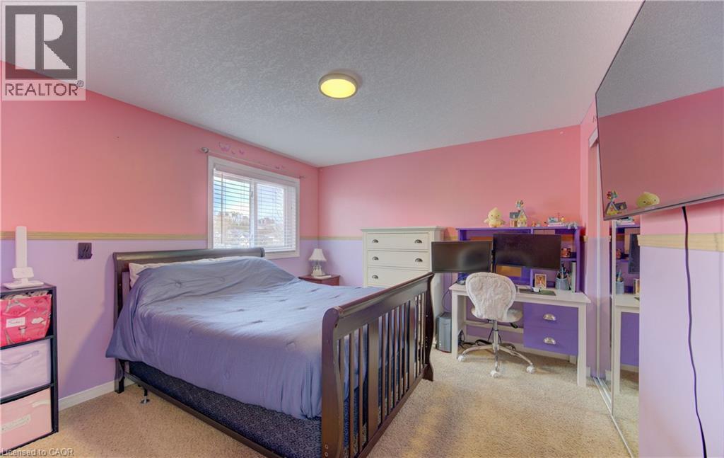 Carpeted room featuring a window with white blinds, a ceiling-mounted light fixture, and a built-in mirrored closet door