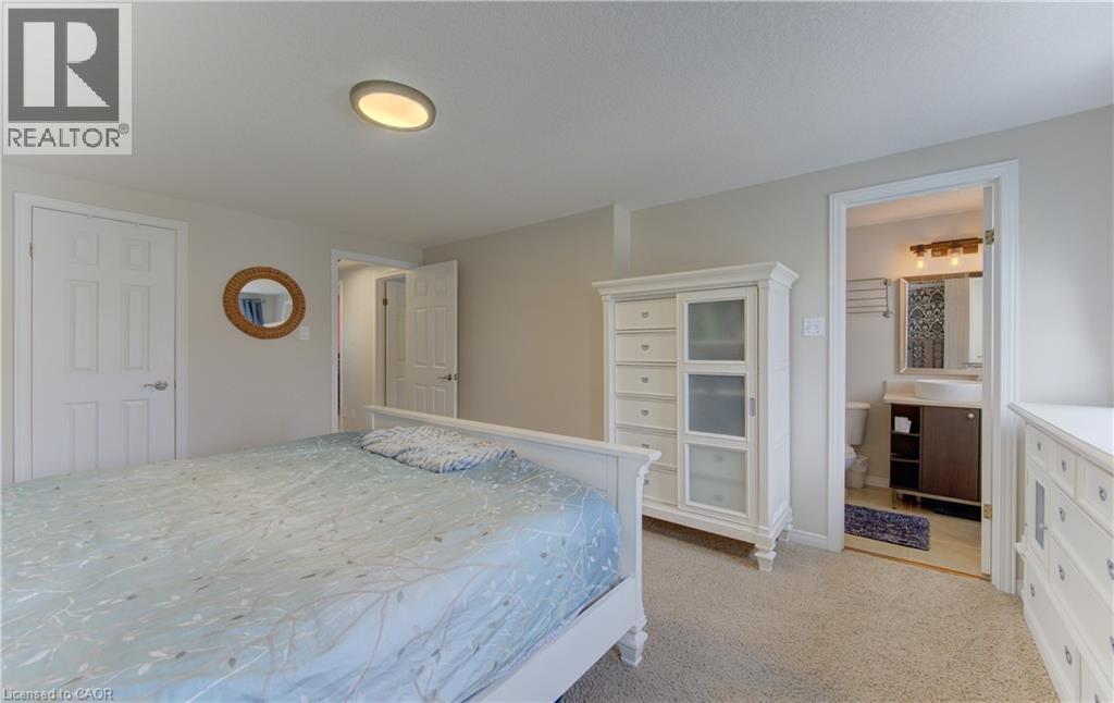 Carpeted bedroom with neutral wall tones and a ceiling-mounted light fixture