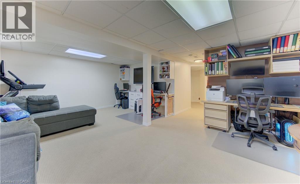 Spacious finished lower level featuring recessed lighting, a drop ceiling, and carpet flooring