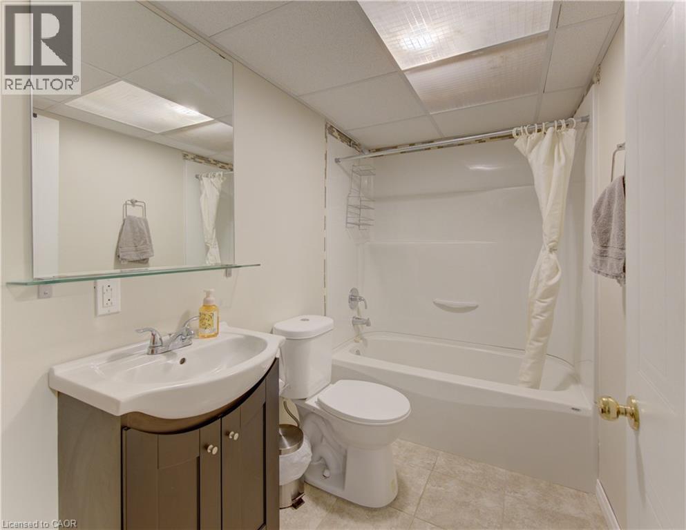 Full bathroom featuring a white bathtub/shower combination, a toilet, and a vanity with an integrated sink