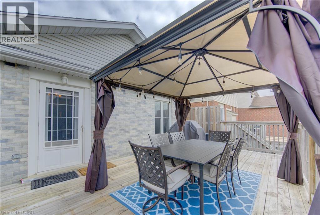 Expansive deck featuring a shaded gazebo, string lighting, and direct exterior access