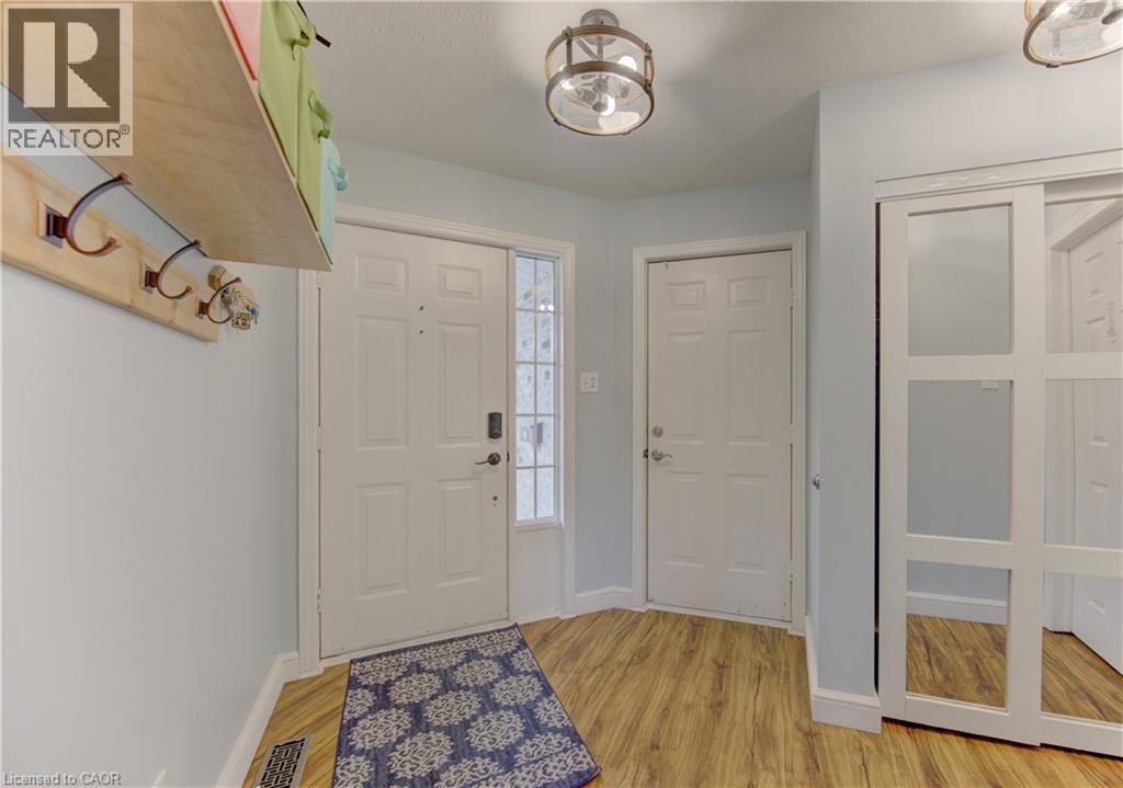 Entryway featuring wood-finish flooring and light blue wall color