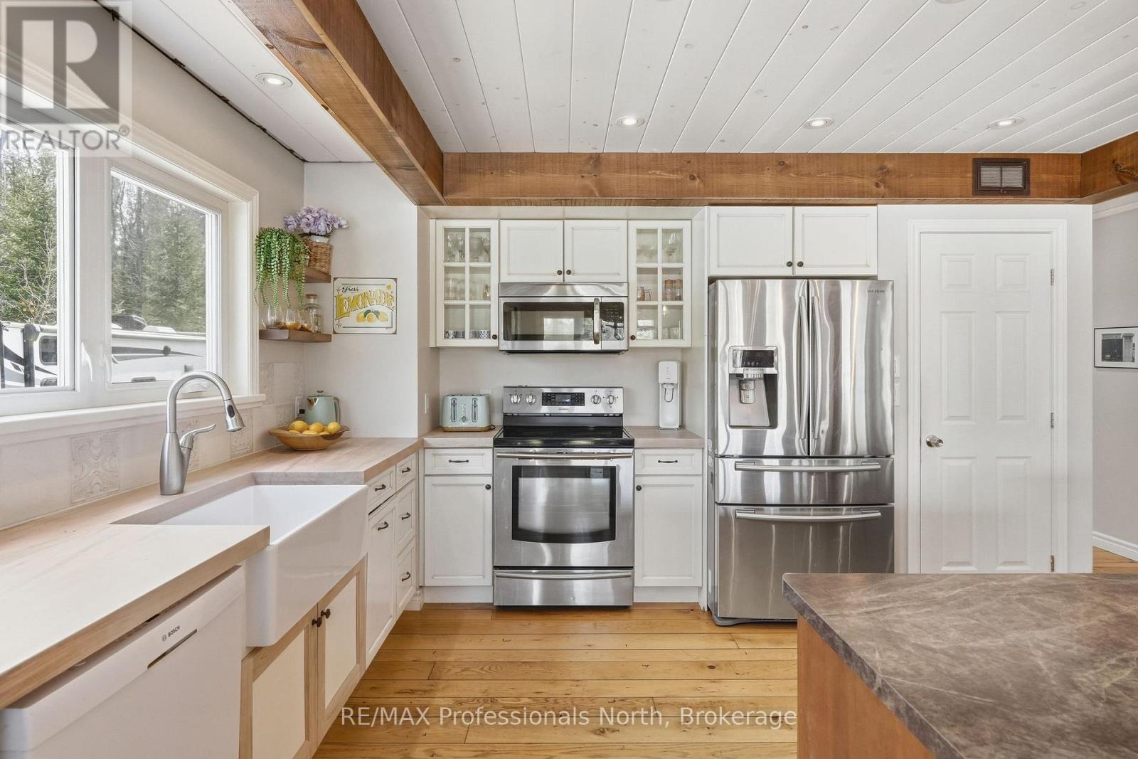 Stainless microwave and waterline in fridge.