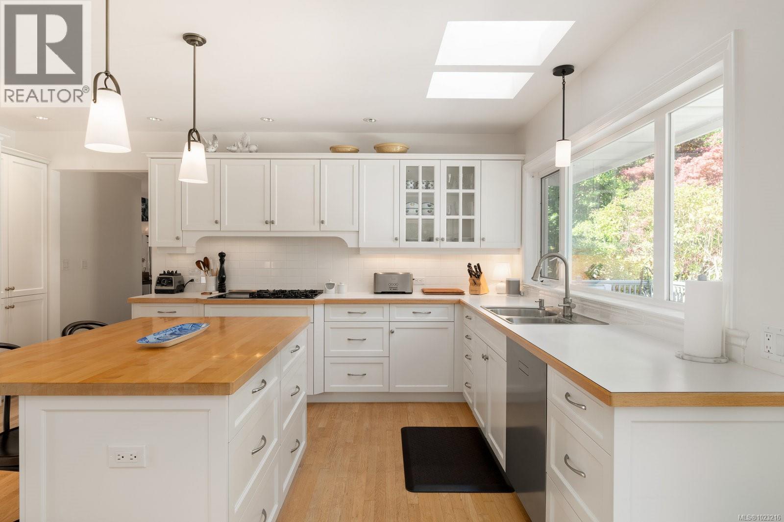 Bright and functional kitchen layout with skylights and generous prep space