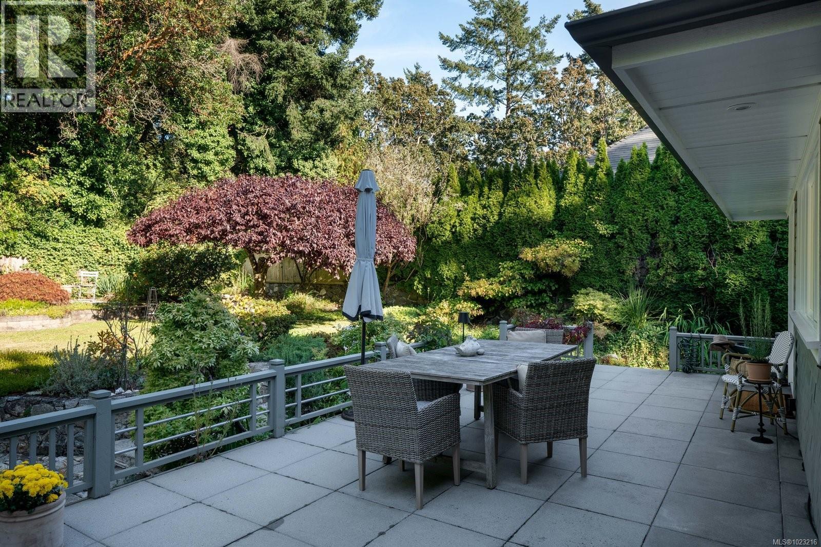 Expansive patio surrounded by manicured gardens -perfect for outdoor dining and morning coffee