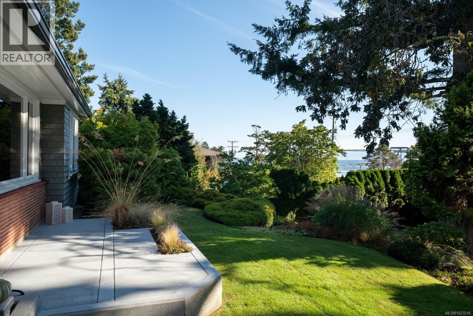 Front porch featuring ocean/mountain views and mature gardens