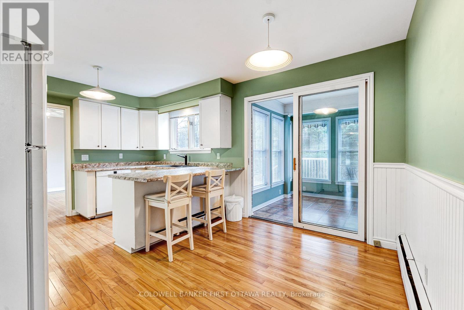 Breakfast bar & dinette with patio door to sunroom