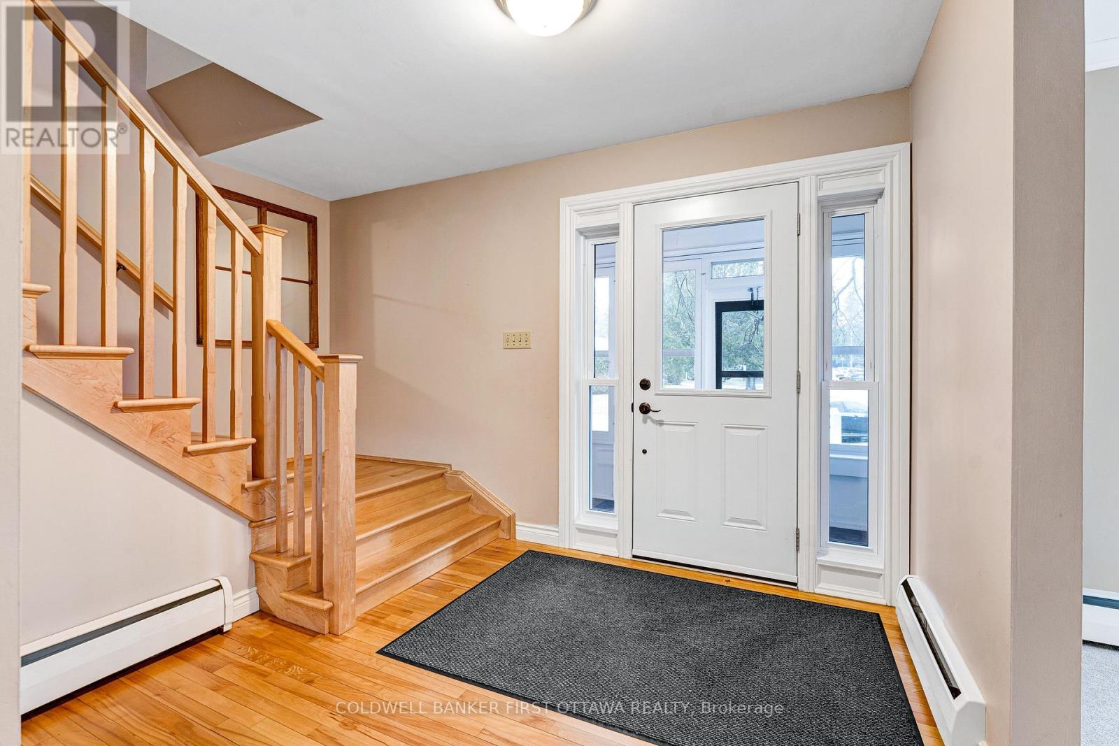 Light bright foyer with hardwood flooring
