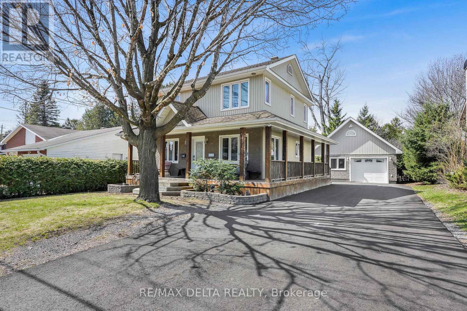 Front view with new & wide driveway to garage.