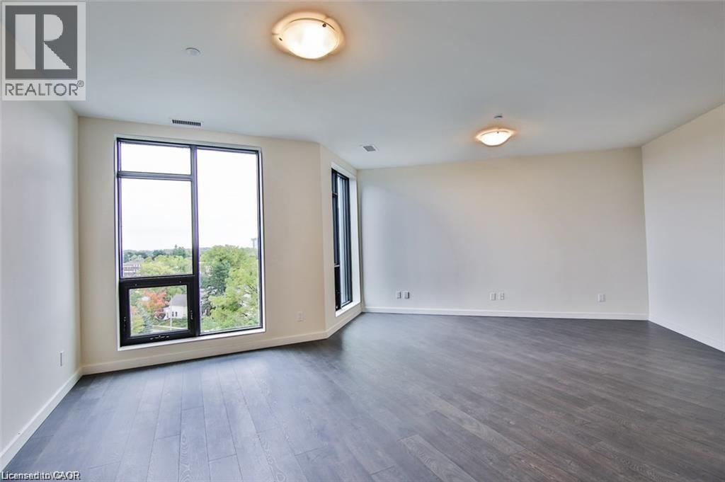 Empty room with dark wood finished floors and baseboards