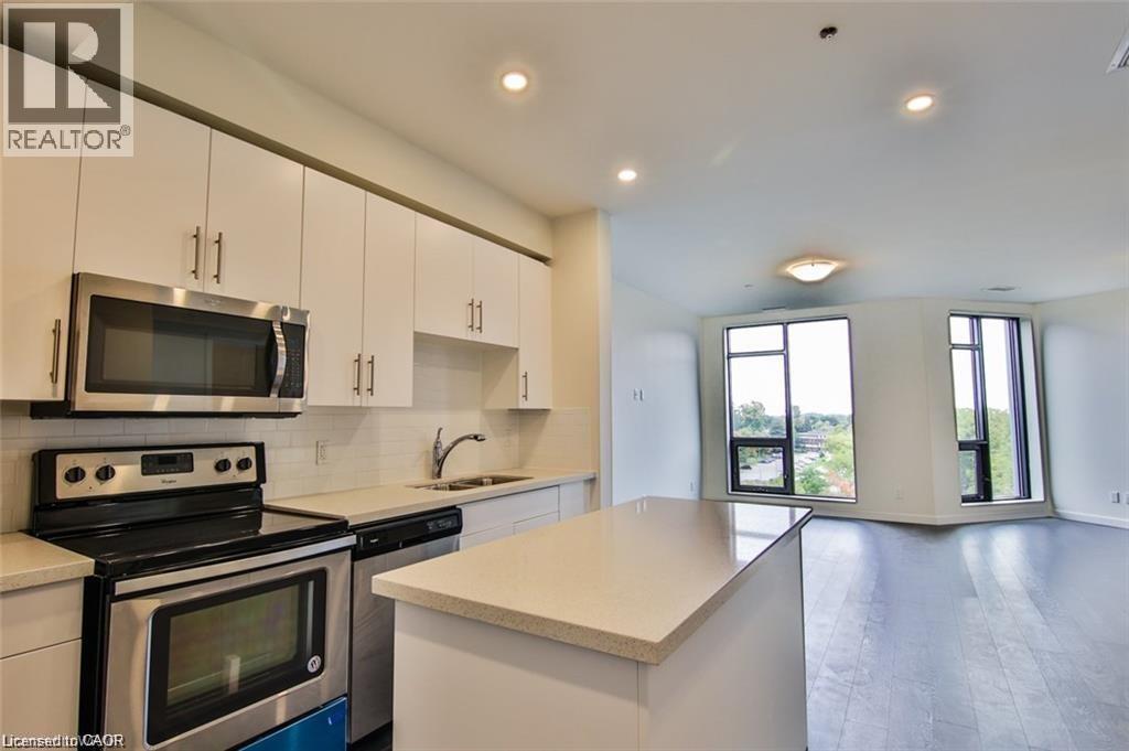 Kitchen featuring stainless steel appliances, white cabinets, open floor plan, recessed lighting, and decorative backsplash