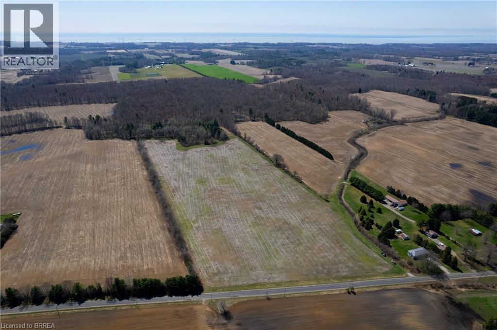 Expansive agricultural land featuring multiple cultivated fields and wooded areas