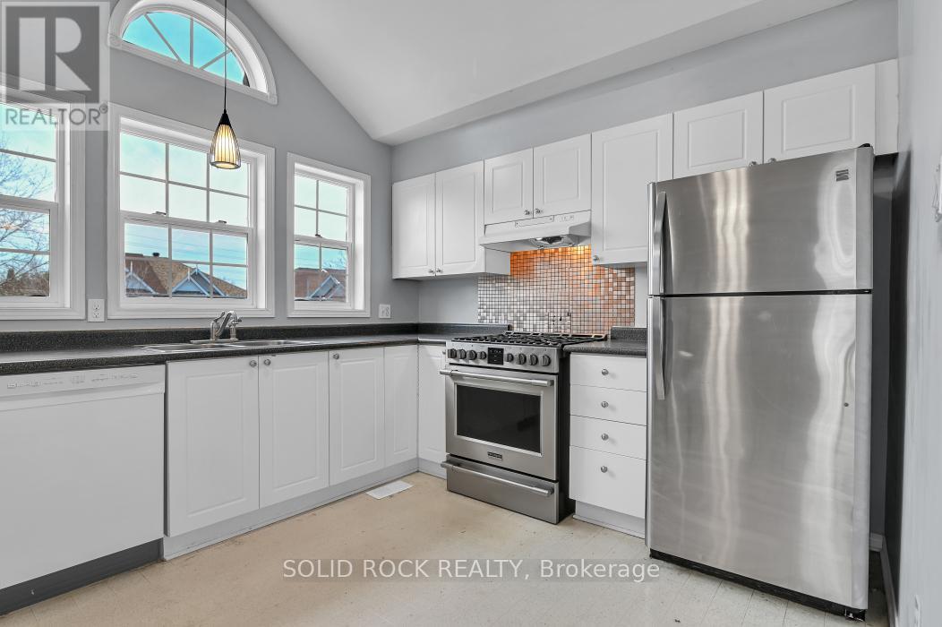 Kitchen has cathedral ceilings and gas stove