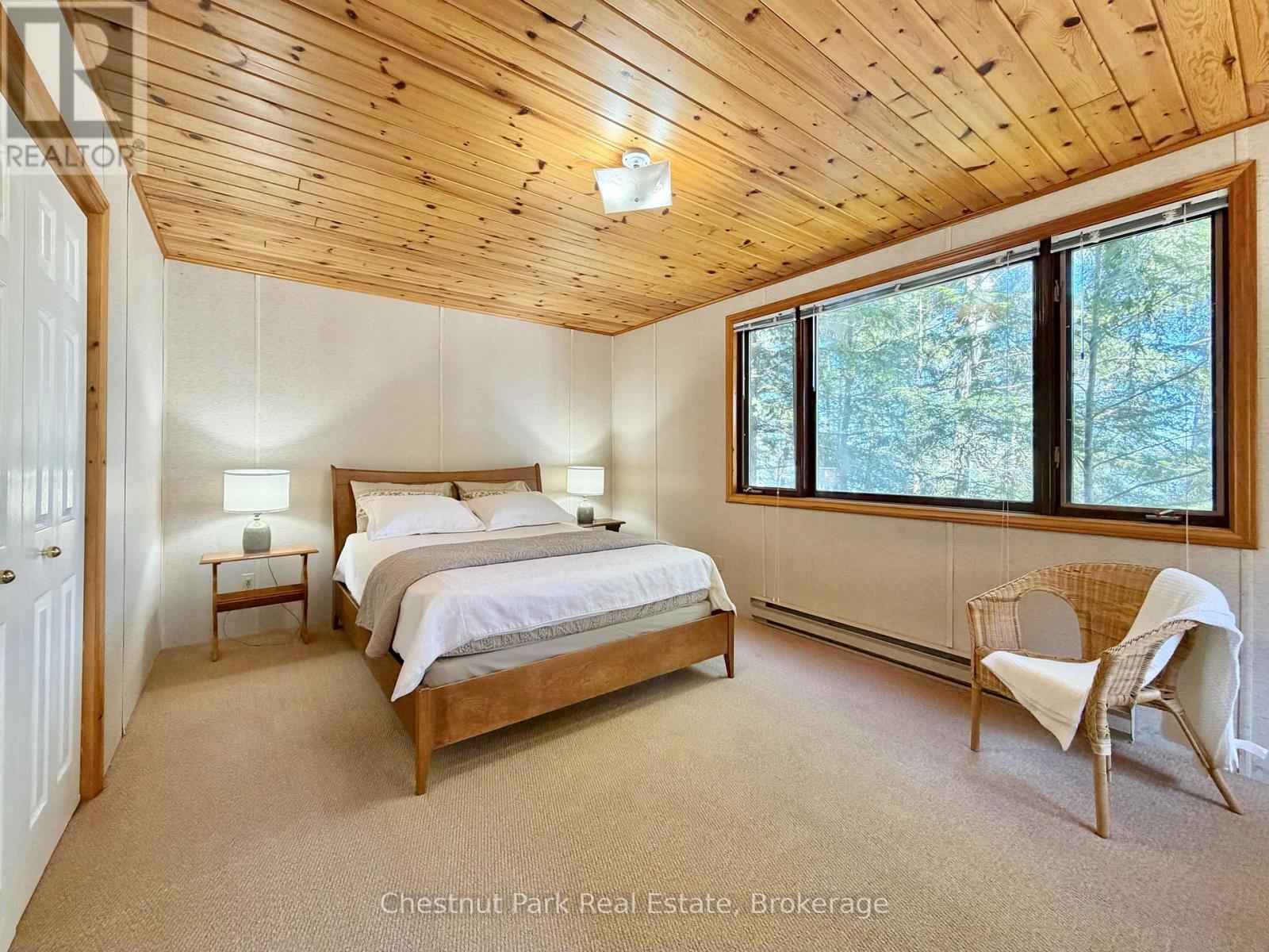 Large lakeside primary bedroom with double closet