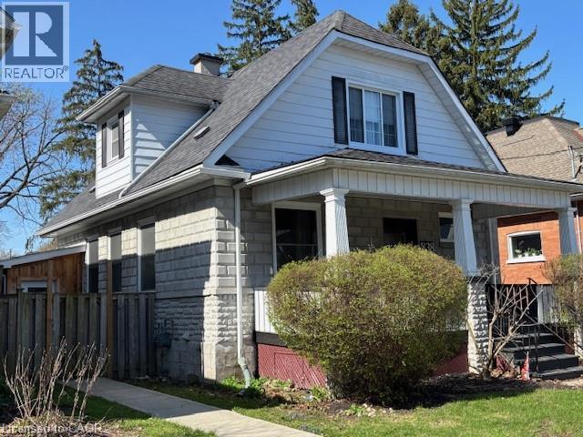 Traditional residence featuring a covered front porch with columnar supports