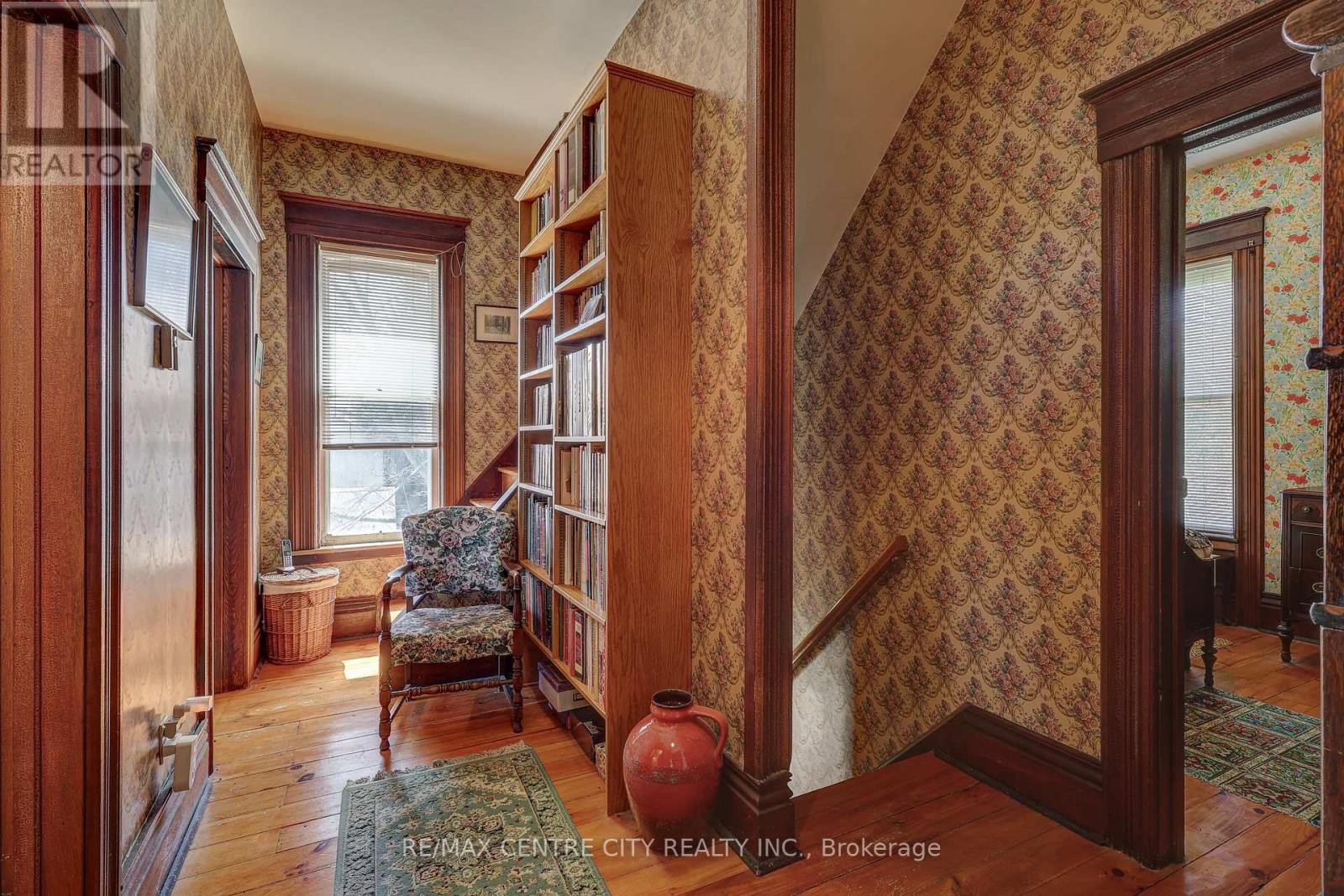 Stairs to kitchen + hallway to bathrooms