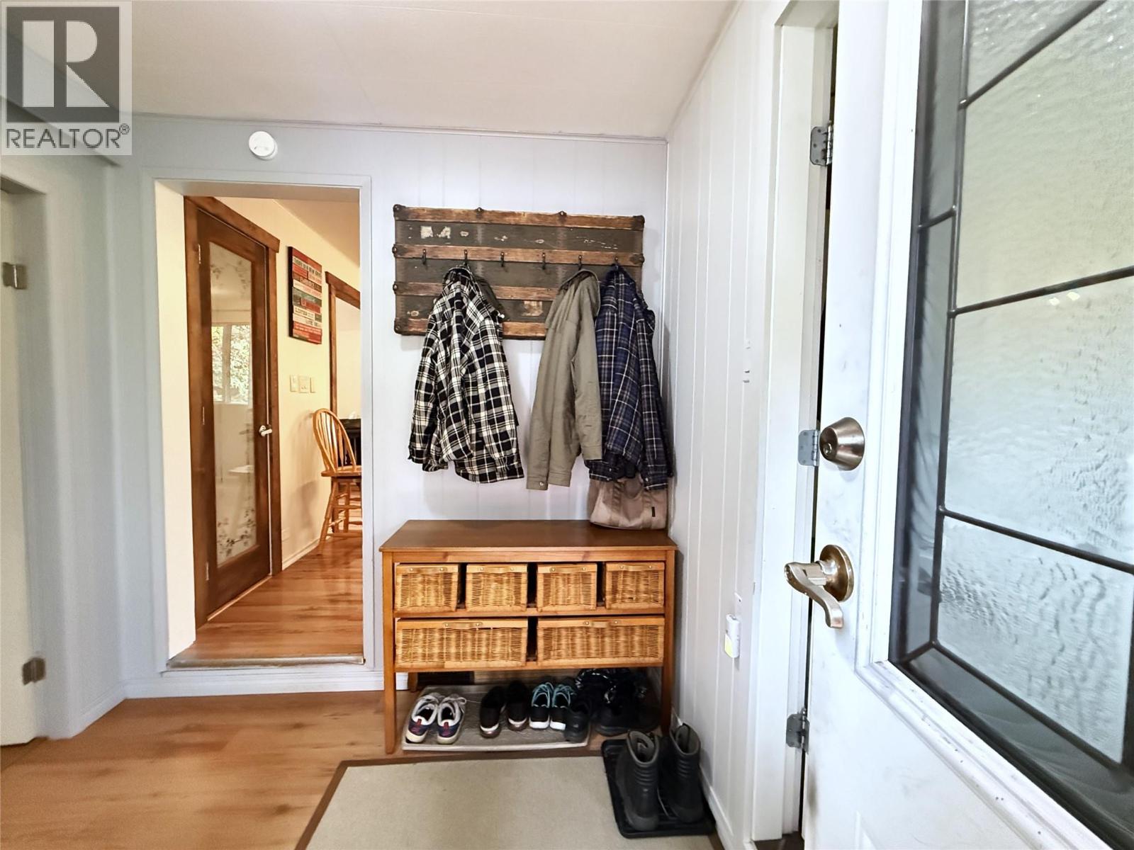 Looking from back door into rear foyer/hall and through to Kitchen