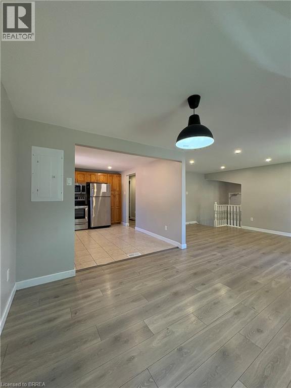 Unfurnished living room with light wood-type flooring and recessed lighting