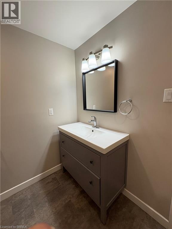 Bathroom featuring vanity and baseboards