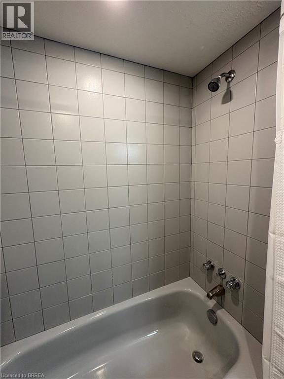 Full bath featuring shower / tub combo
