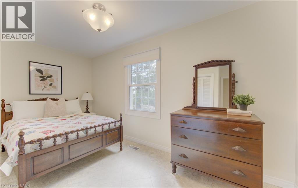 Light-toned walls with a window featuring a white blind, recessed lighting, and tile flooring