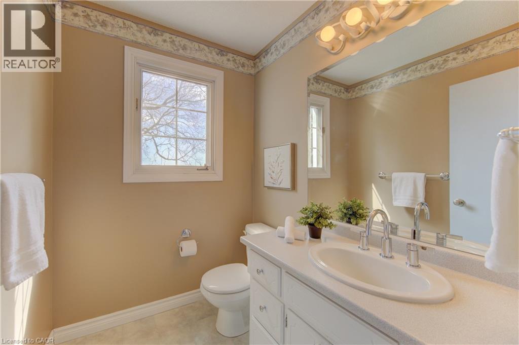 Bathroom featuring a vanity with an oval sink, chrome faucet, and a large mirror