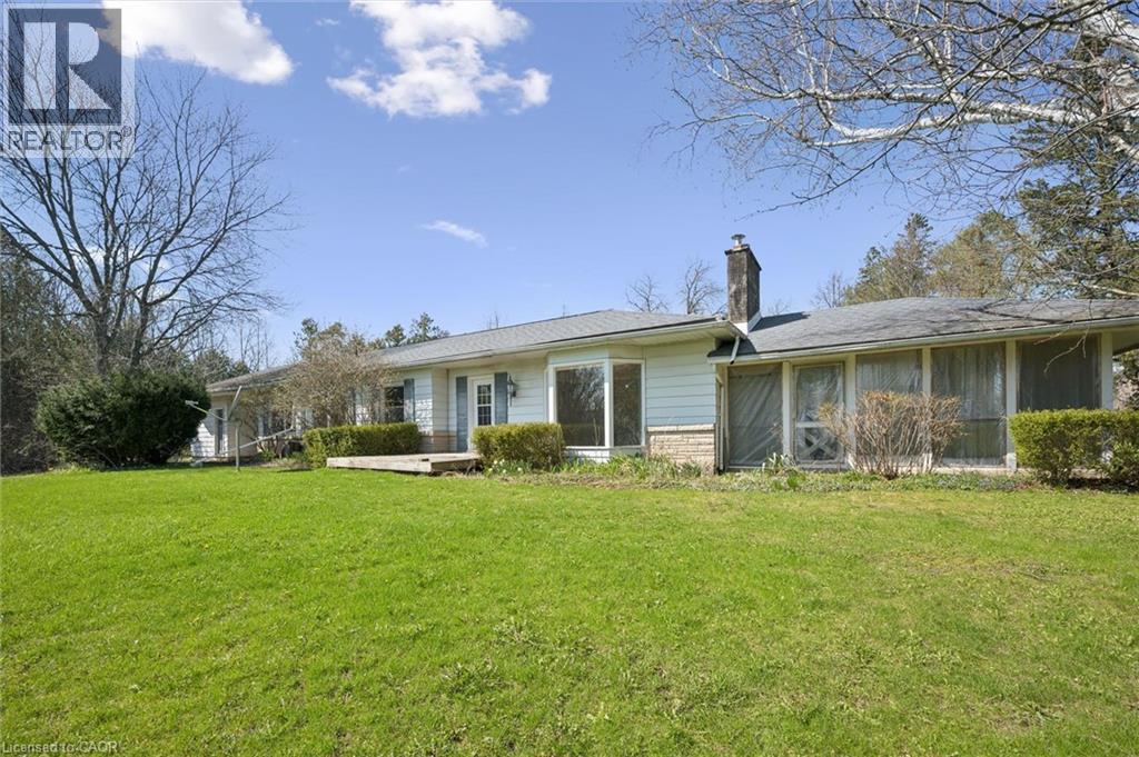 Ranch-style residence featuring white siding and a stone facade