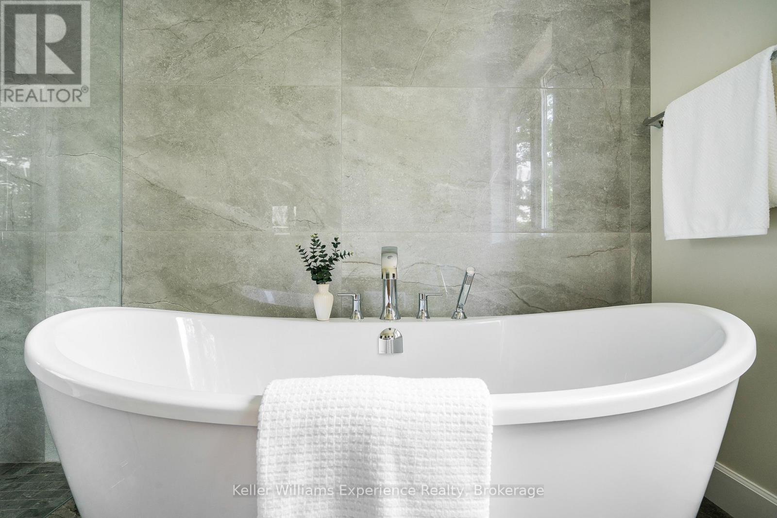 Elegant Soaker Tub Framed by Porcelain Tile Wall