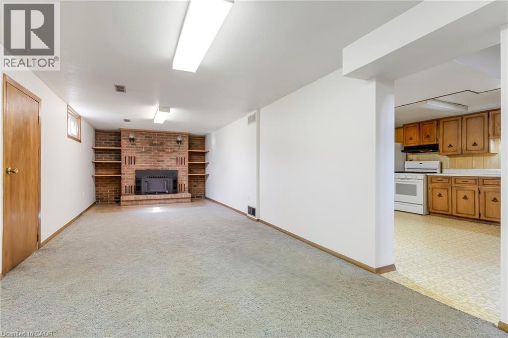 Long and spacious rec roomj with built in and fireplace.  This room could be reduced and a bedroom added.