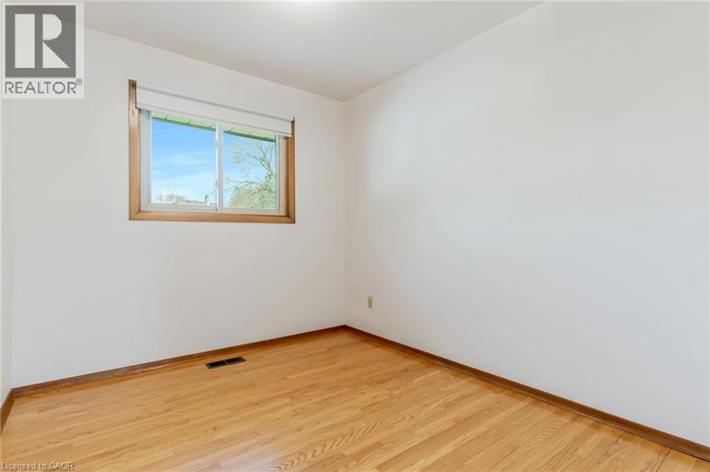 Bedroom 1 with window overlooking the backyard