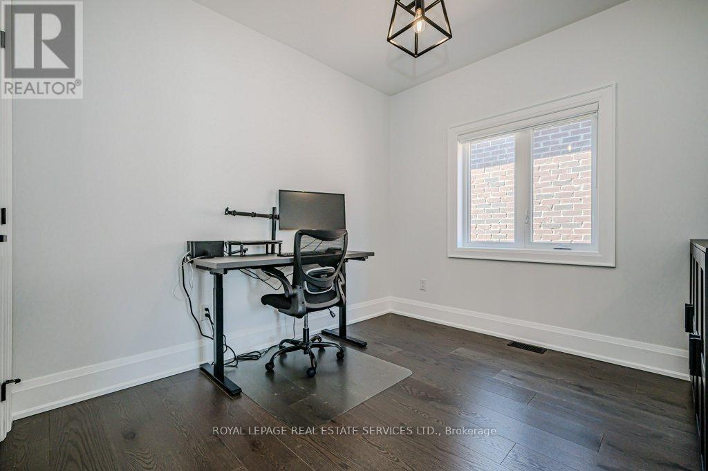Second Bedroom With Wide Plank Hardwood Flooring