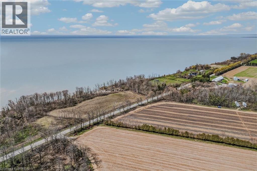 Expansive aerial perspective showcasing a significant body of water alongside agricultural land