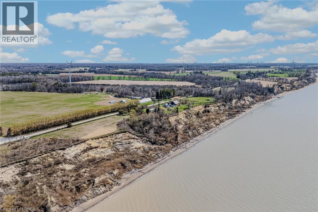 Expansive waterfront property featuring a natural coastline, substantial land area, and a private road