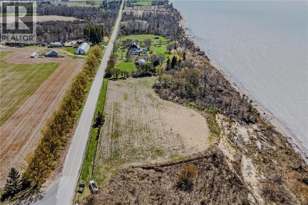 Expansive waterfront acreage featuring cultivated fields and mature trees