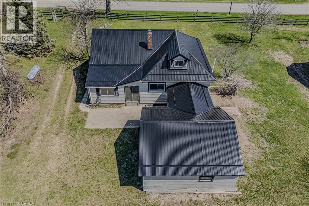 Aerial perspective highlighting the property's dark metal roofing system