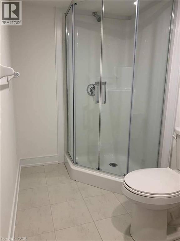 Corner shower enclosure with clear glass panels and chrome hardware