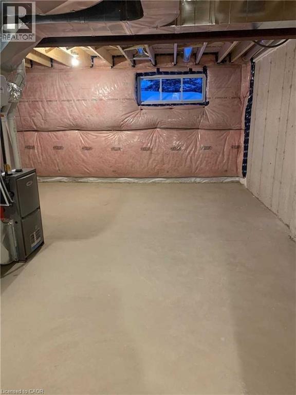 Unfinished basement featuring exposed ceiling joists, concrete flooring, insulated walls, an egress window, and visible HVAC ductwork
