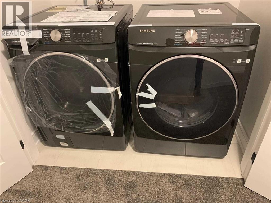 New Samsung front-load washer and dryer set with dark finishes and chrome accents