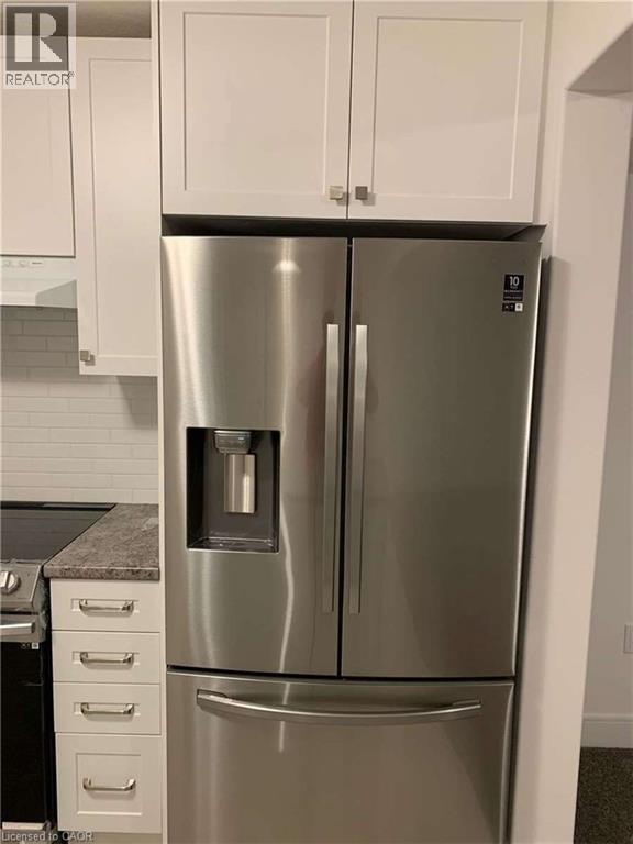 Stainless steel French door refrigerator with an external ice and water dispenser