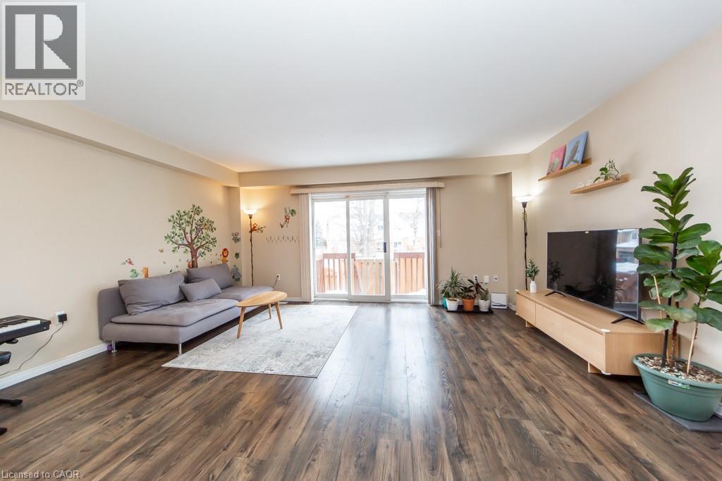Living area with dark wood-style floors and baseboards