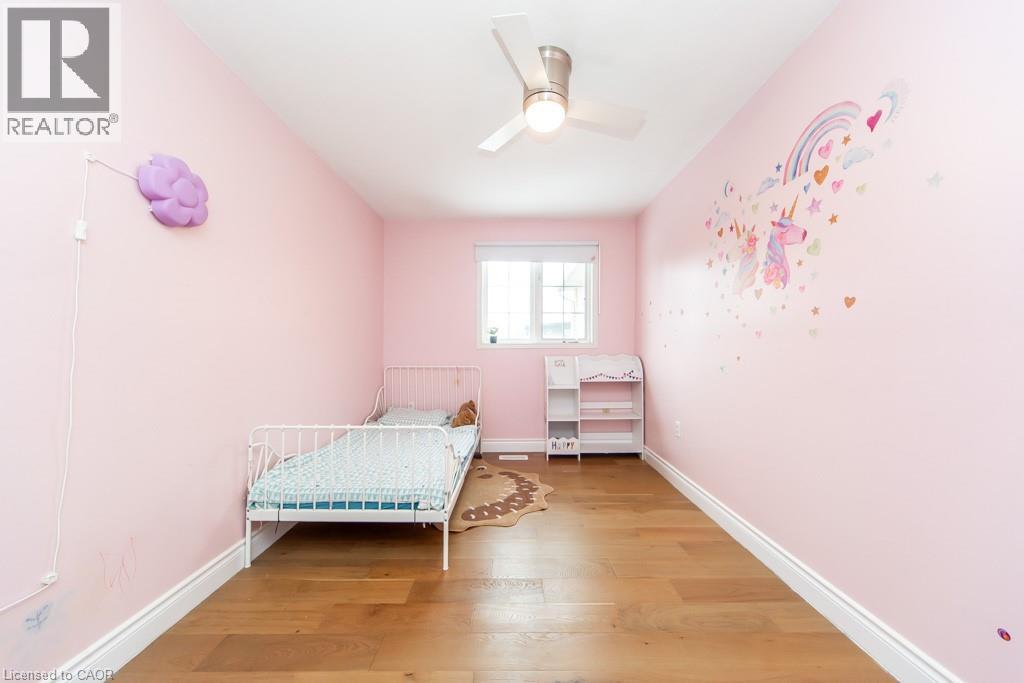 Bedroom with light wood-style floors and a ceiling fan