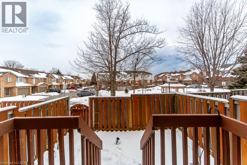 Snow covered deck featuring a residential view