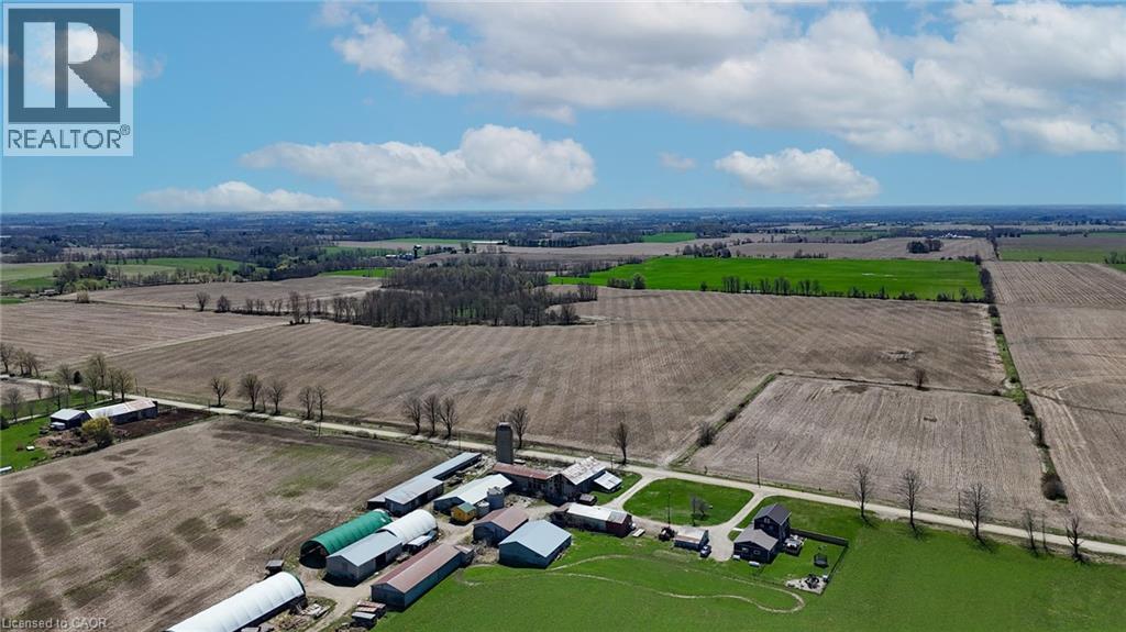 Expansive agricultural property featuring multiple outbuildings, a silo, and substantial cultivated land